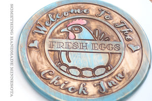 The Chick Inn sign with fresh eggs in teal